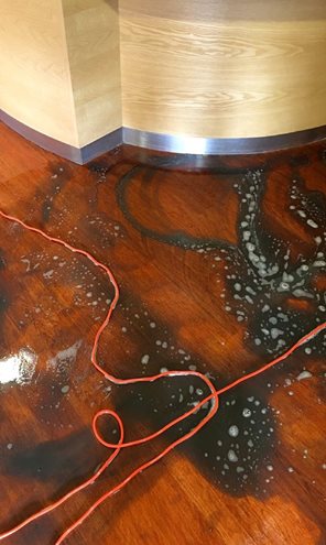 Hard flooring may appear clean to the eye but isn’t always clean. The owner of this floor thought the black spots were part of the design – it was in fact dirt.